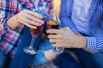 Couple in love drinks a red wine on summer picnic
