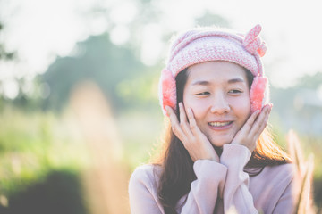 Spring - Beauty young woman outdoor enjoy nature, She put on the earmuff and breathed fresh air in the morning.