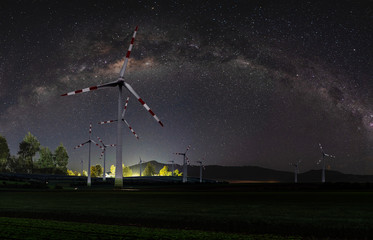 Natural wind power plant and sustainable eco-friendly energy resources at night with sky full of...