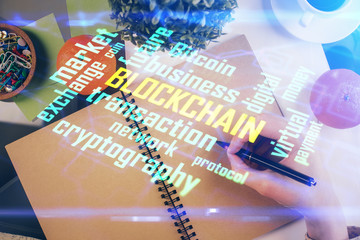 Cryptocurrency hologram over woman's hands writing background. Concept of blockchain. Multi exposure