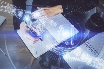 Double exposure of writing hands on background with data solution hologram on front. Technology concept. TOP view.