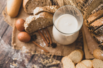 Top view milk in a glass bottle placed on a wooden table with ingredients