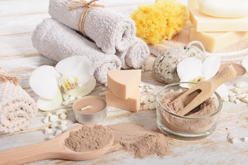 Fototapeta na wymiar home spa, candles, pumice, natural soap, dry powder for making a face mask,