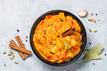 Chicken tikka masala with rice on black top view.