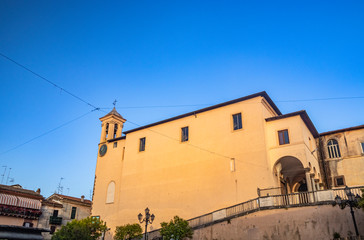 Fototapeta na wymiar The Convent of S. Maria delle Grazie, in Santa Maria square. The bell tower with the clock. The blue sky at sunset. Zagarolo, Province of Rome, Lazio, Italy