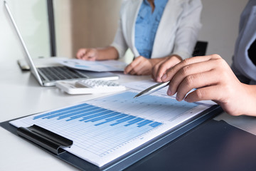 Two bussiness leader women discussing the charts and graphs showing the results