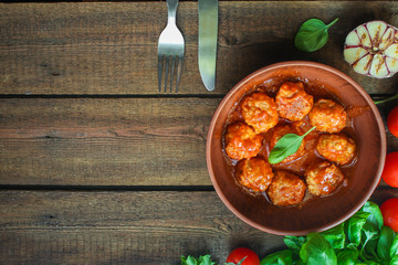 meatballs in tomato sauce and basil (meat dish). food background. top view. copy space