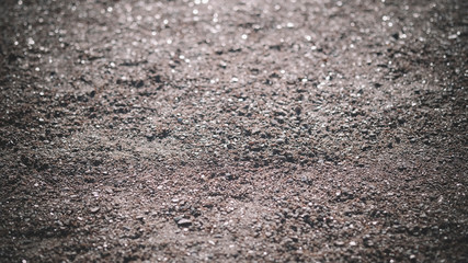 The soil under your feet with small stones with a textured surface. Texture or background.