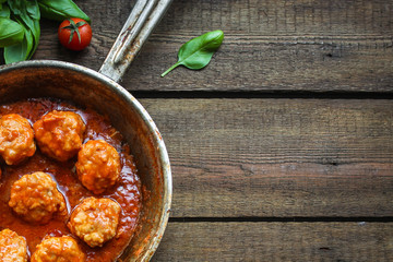 meatballs in tomato sauce and basil (meat dish). food background. top view. copy space