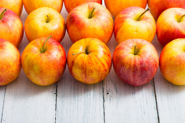 apple fruits in a row, white wooden table background