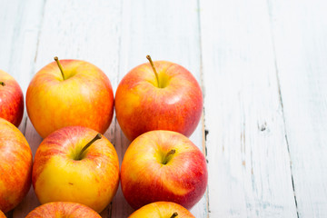 apple fruits in a row, white wooden table background
