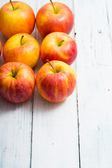 apple fruits in a row, white wooden table background