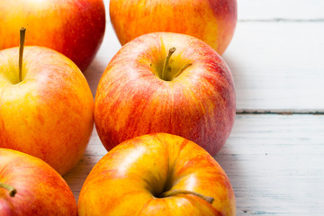 apple fruits in a row, white wooden table background