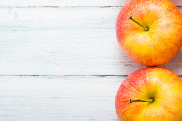 apple fruits in a row, white wooden table background