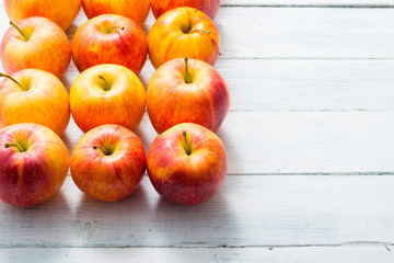 apple fruits in a row, white wooden table background