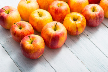 apple fruits in a row, white wooden table background