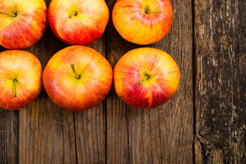 apple fruits in a row, old weathered wood table background