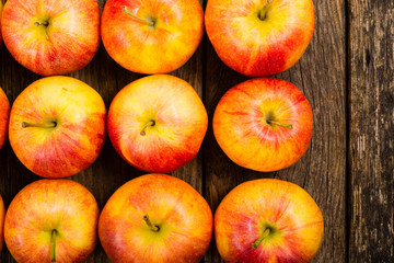 apple fruits in a row, old weathered wood table background