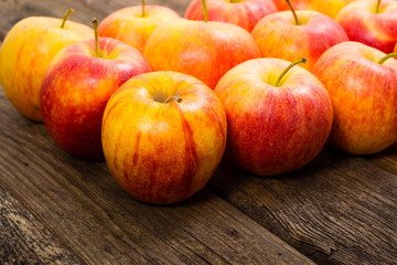 apple fruits in a row, old weathered wood table background