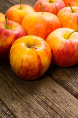 apple fruits in a row, old weathered wood table background
