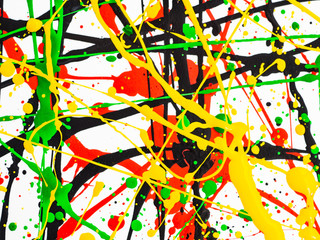 Art splashed spilled yellow green red black paint. expressionism.