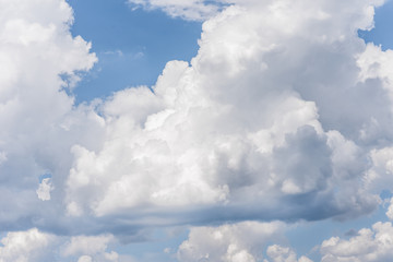 Blue sky background with a fluffy clouds