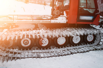 Snow clearance. Snowmobile. snowmobile goes to work in the evening at sunset