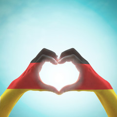 Germany national flag on people heart shape hands.