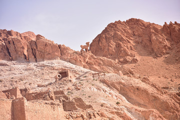 Obraz premium CHEBIKA, TN - JULY, 2019: Chebika Oasis lies at the foot of the mountains of the Djebel el Negueb and it is known as Qasr el-Shams (Castle of the Sun in Arabic).