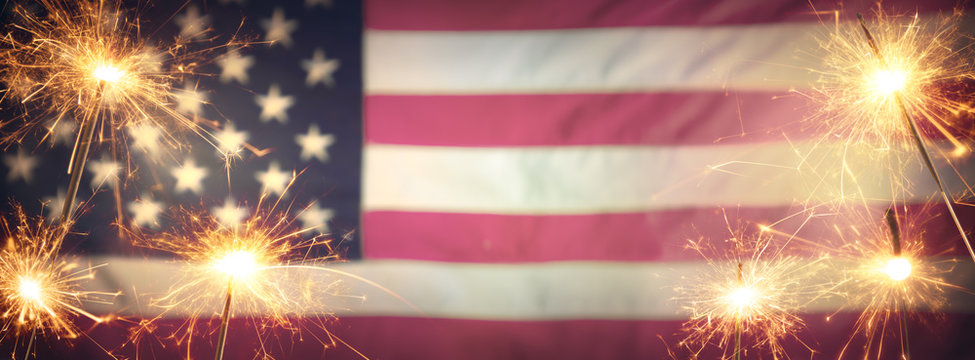 Vintage Celebration With Sparklers And Defocused American Flag - 4th Of July