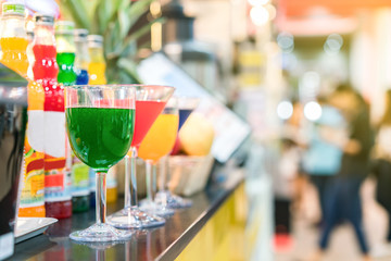 colorful nectar and many in cocktails glass on table with copy space