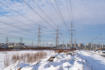 Obraz premium behind snowdrifts high pipes let off steam into the blue sky