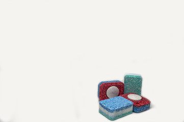 four capsules for the dishwasher on a white background close-up