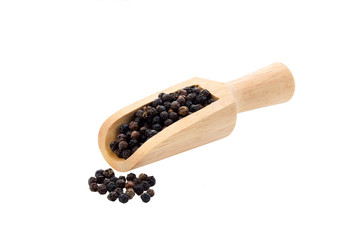Black Pepper corns in wood scoop isolated on white background