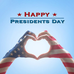 Happy presidents day with American US flag pattern on people hands in heart shape