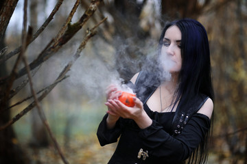 A woman in a witch suit in a forest