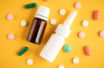 Nasal spray bottle with pills composition, white template bottle on yellow background