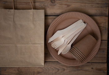 eco paper plate dish fork on old wooden table