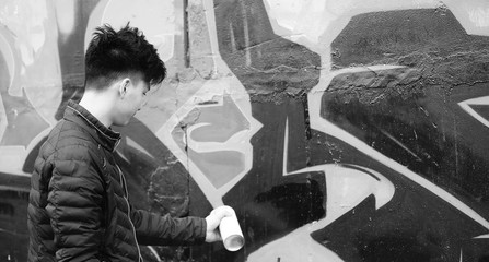 Black White photo of Asian young man outdoors posing