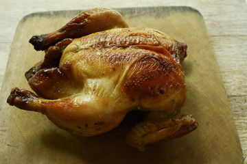 grilled chicken with sweet sauce on wooden chop block in home kitchen