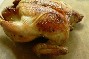 grilled chicken with sweet sauce on wooden chop block in home kitchen