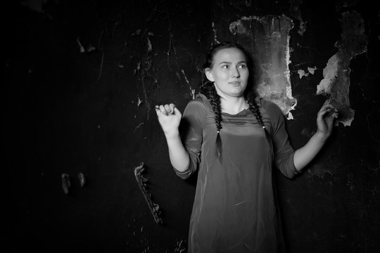 young girl portrait in an old house with burnt walls