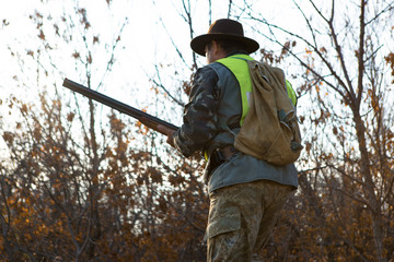 Hunters with a german drathaar and spaniel, pigeon hunting with dogs in reflective vests	