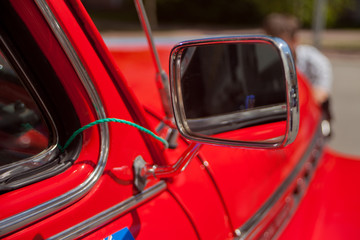 Close up Red retro car rear view mirror.