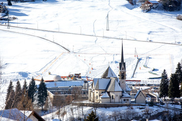 Scenic view of San Vigilio church in winter, Moena, Dolomites, Trento, Trentino Alto Adige, Italy. Church of San Vigilio in Moena. church on a background of mountains