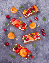 Crisp bread with creme cheese, fruit and berries