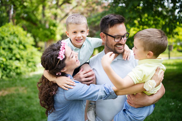 Fototapeta premium Young family with children having fun in nature