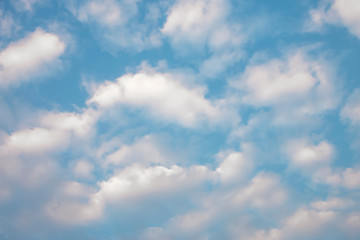 Blue sky with soft white clouds.