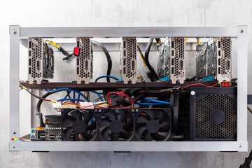 domestic gpu cripto mining rig on wall with selective focus