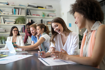 Cheerful coworkers in office during company meeting